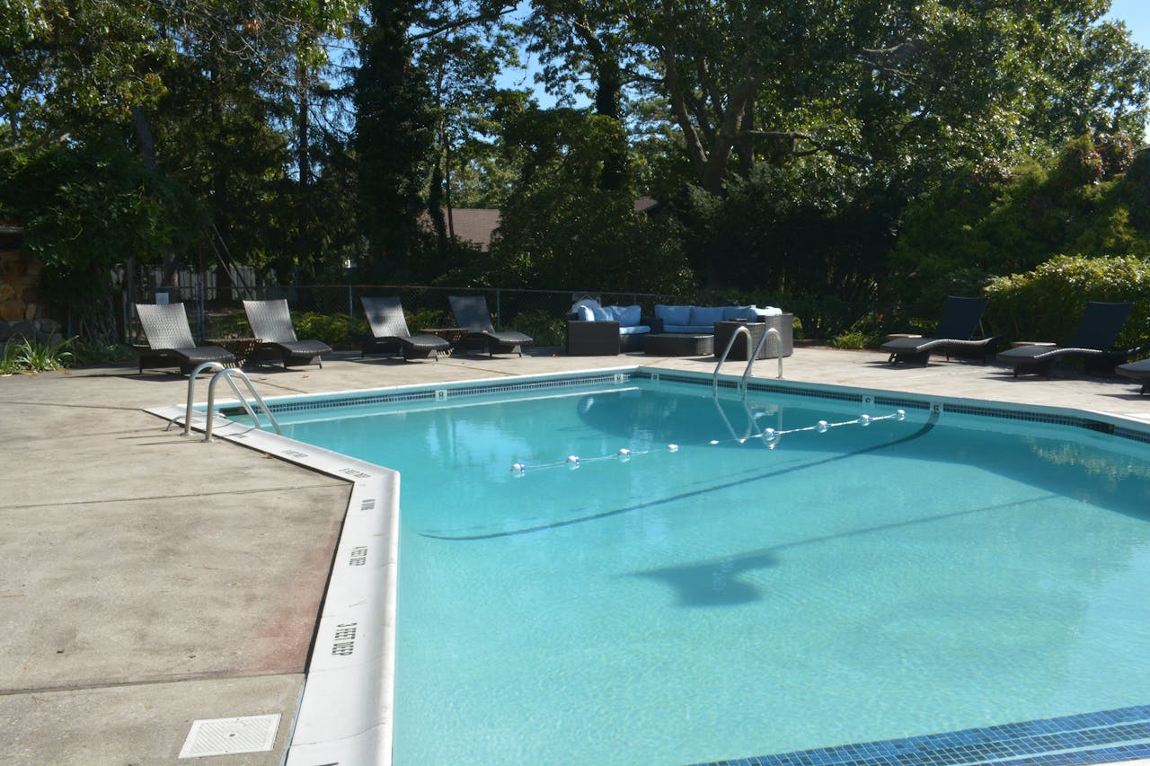 Discover relaxation at this luxurious outdoor poolside retreat in Hampton Bays, NY.